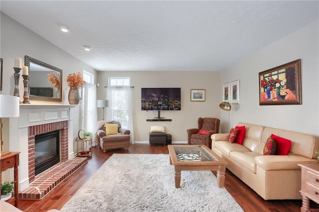 living room with dark hardwood / wood-style floors and a fireplace