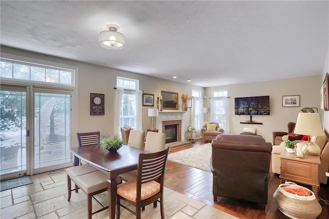 dining room with a brick fireplace