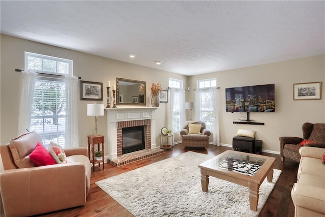 living room featuring hardwood / wood-style flooring, a healthy amount of sunlight, and a fireplace