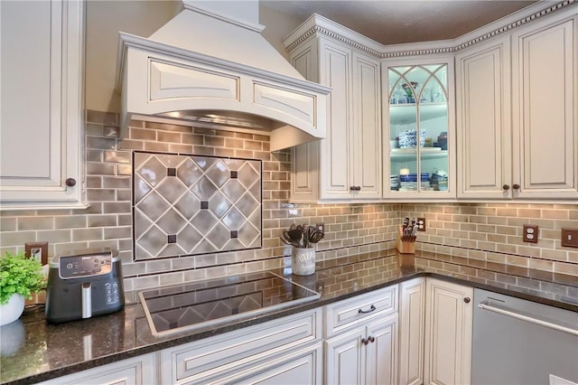 kitchen with black electric cooktop, decorative backsplash, custom exhaust hood, and white cabinets