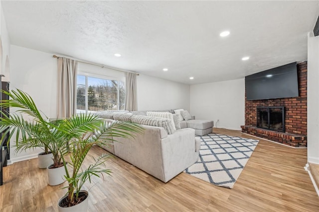 living room featuring a fireplace and hardwood / wood-style floors