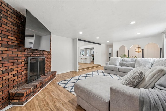 living room featuring light hardwood / wood-style flooring and a fireplace