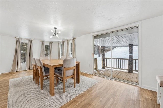 dining area featuring a notable chandelier and light hardwood / wood-style floors