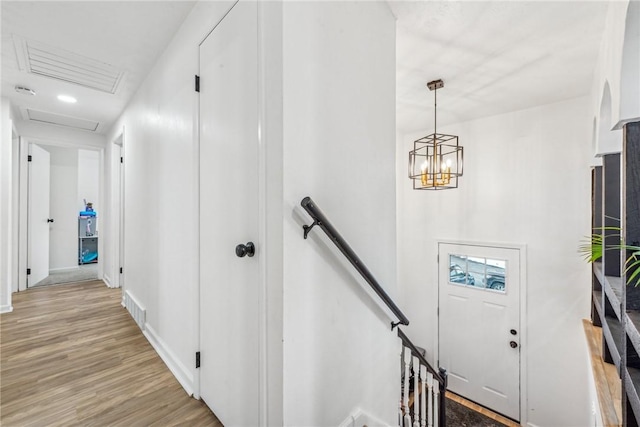 interior space featuring an inviting chandelier and hardwood / wood-style flooring