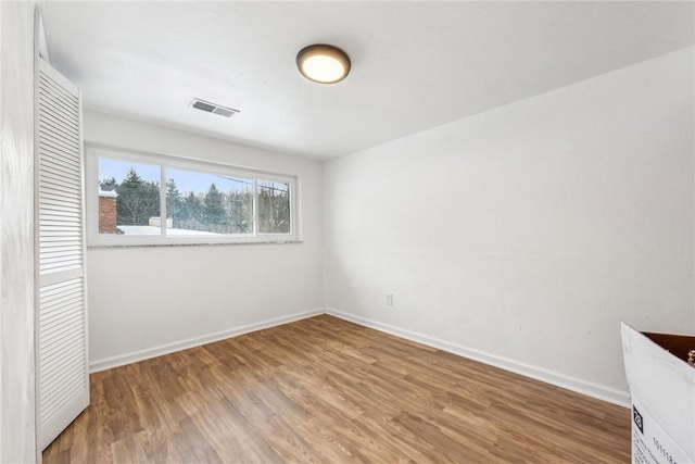 unfurnished bedroom featuring hardwood / wood-style flooring