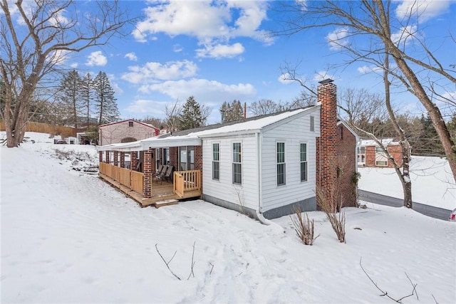 view of snow covered rear of property