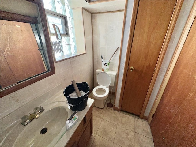 bathroom featuring tile walls, tile patterned flooring, sink, and toilet