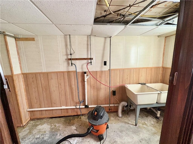 basement featuring a drop ceiling and sink