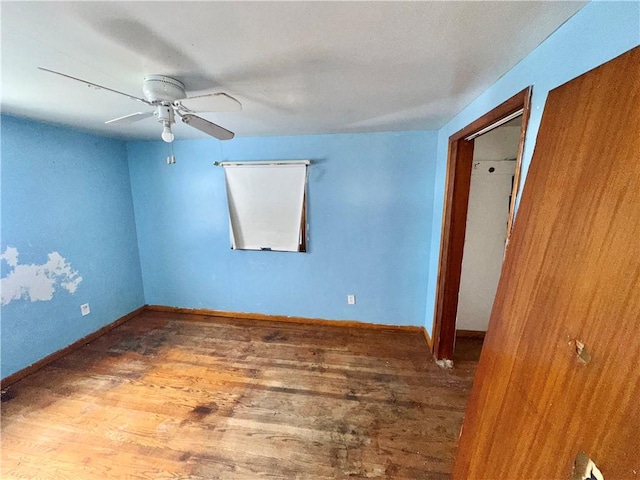 spare room featuring ceiling fan and hardwood / wood-style floors