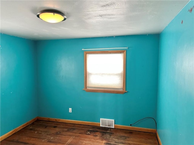 unfurnished room with wood-type flooring