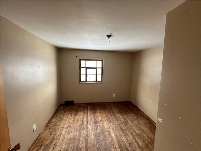 empty room with wood-type flooring