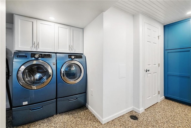 laundry room featuring cabinets and washing machine and clothes dryer