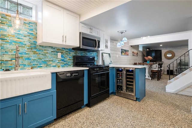 kitchen with white cabinetry, beverage cooler, blue cabinetry, hanging light fixtures, and black appliances