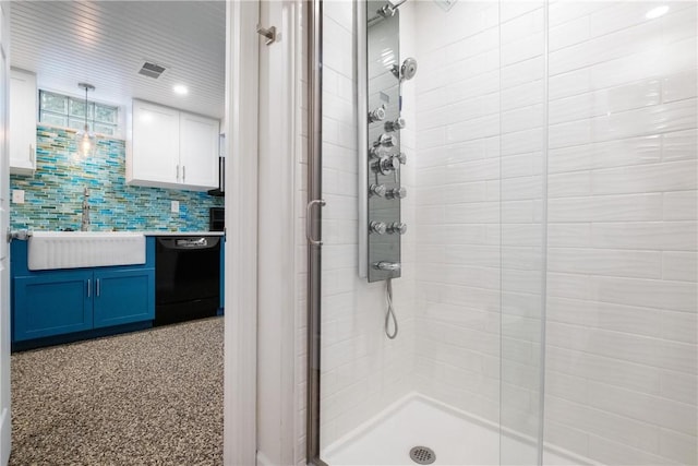 bathroom featuring sink, walk in shower, and tasteful backsplash