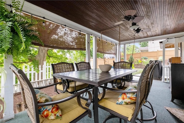 sunroom / solarium featuring ceiling fan and wood ceiling