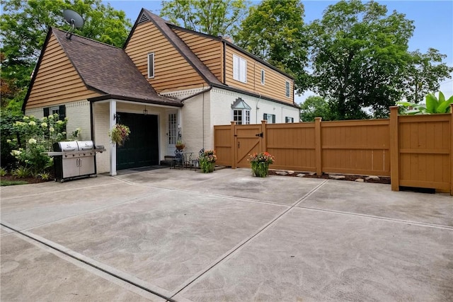 exterior space with a garage and a grill