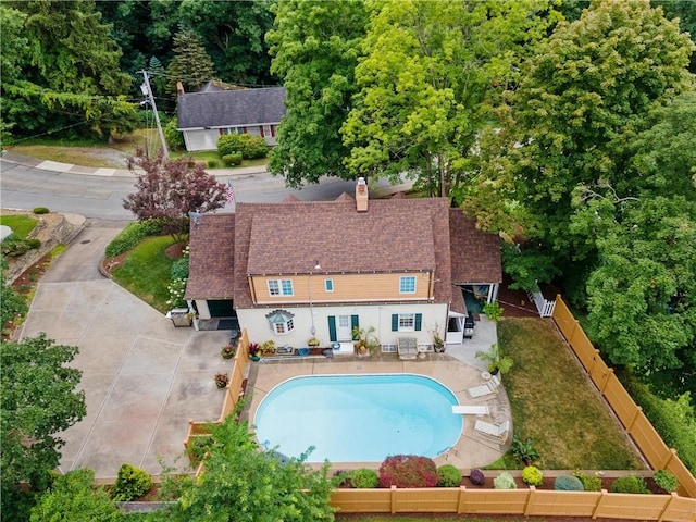 view of swimming pool featuring a lawn, a diving board, and a patio area