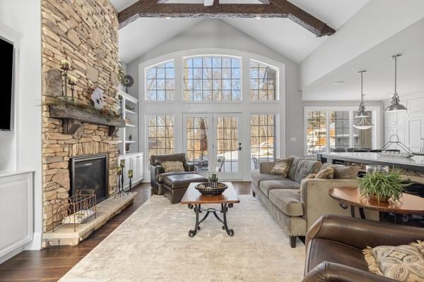 living room featuring beamed ceiling, french doors, high vaulted ceiling, dark hardwood / wood-style floors, and a fireplace