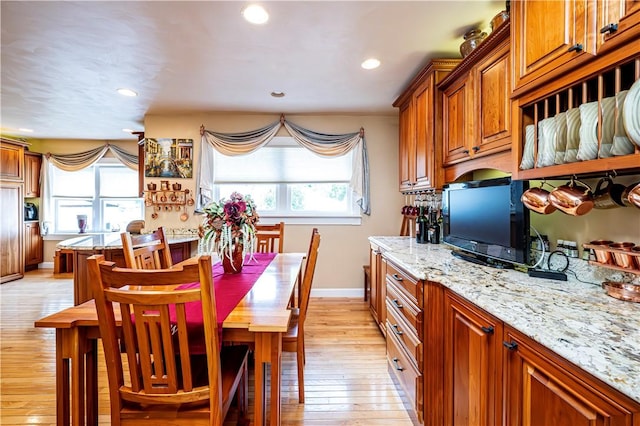 kitchen featuring light stone countertops and light hardwood / wood-style floors