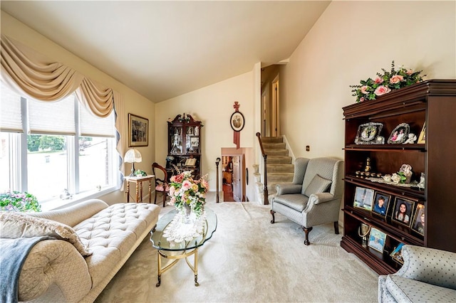 carpeted living room featuring vaulted ceiling