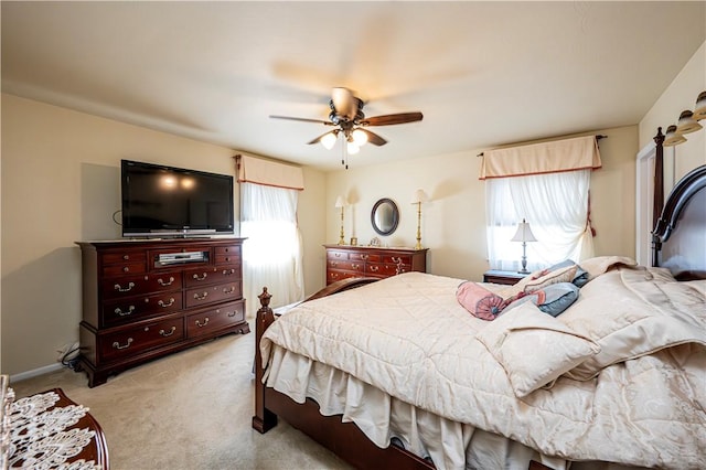 bedroom with ceiling fan and light colored carpet