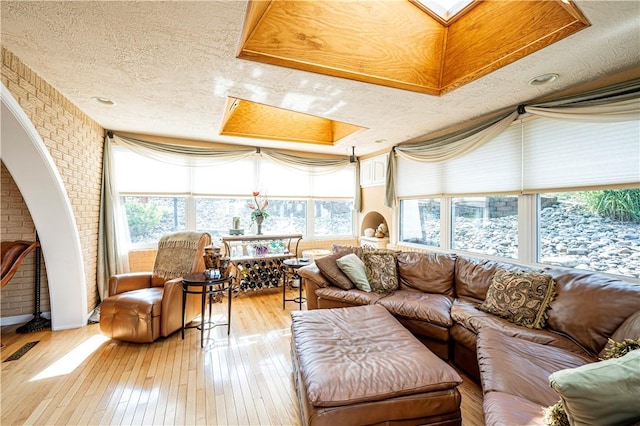 sunroom / solarium with a skylight and a tray ceiling