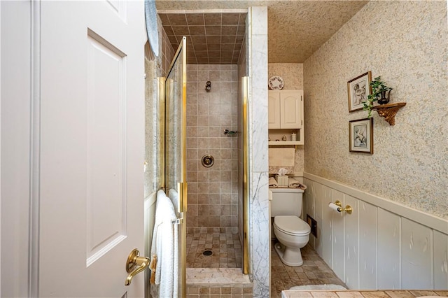 bathroom with toilet, tile patterned flooring, and walk in shower