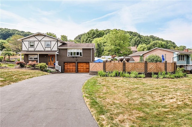 english style home featuring a front yard and a garage