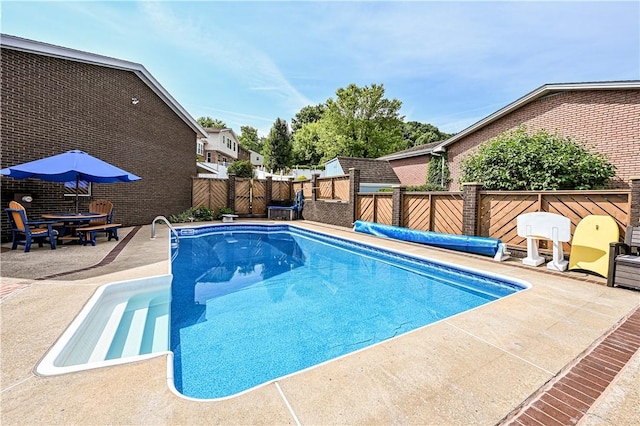 view of swimming pool with a patio area