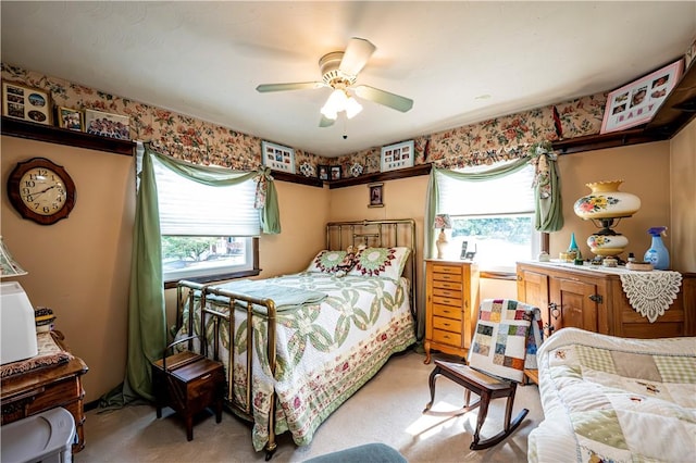 bedroom with ceiling fan and light colored carpet