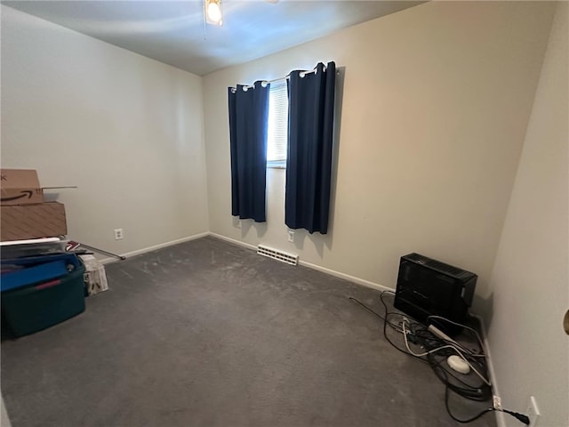 misc room with dark carpet