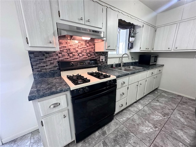 kitchen with gas range oven, backsplash, and sink