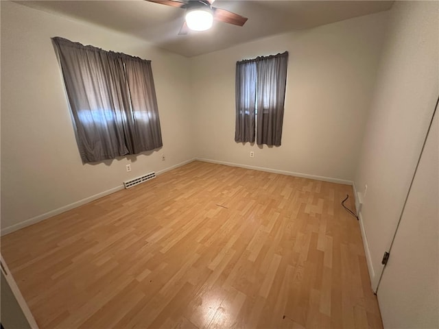 spare room featuring ceiling fan and light hardwood / wood-style flooring