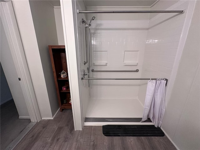 bathroom featuring a shower with shower curtain and hardwood / wood-style floors