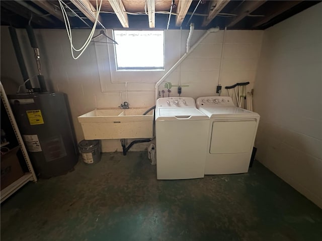 washroom featuring water heater, washing machine and clothes dryer, and sink