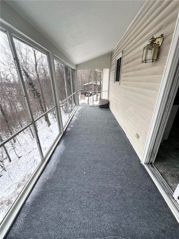 unfurnished sunroom with lofted ceiling and plenty of natural light