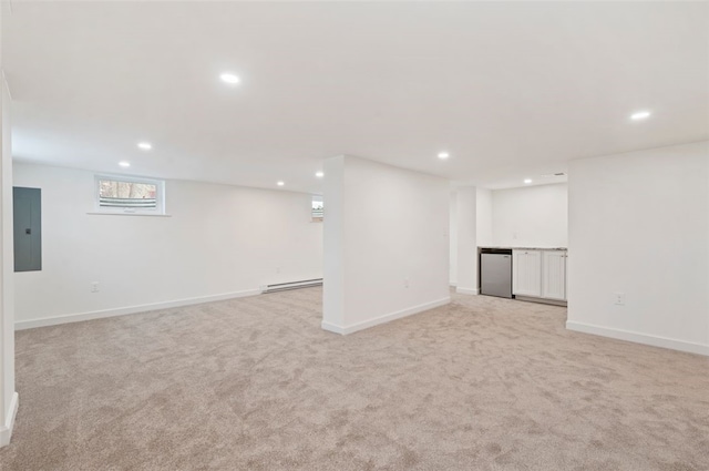 basement featuring electric panel, fridge, light carpet, and a baseboard heating unit