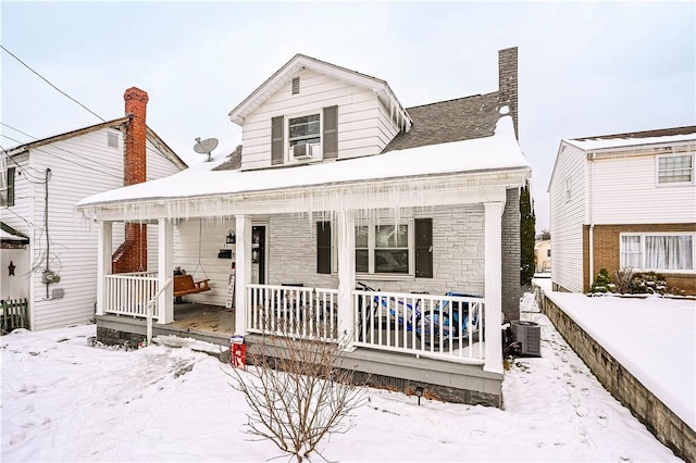 view of front facade featuring covered porch and cooling unit