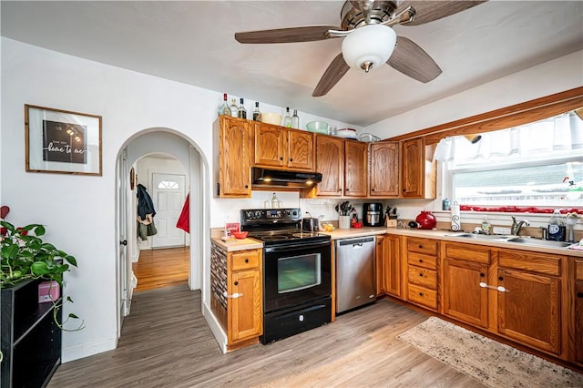 kitchen featuring dishwasher, light hardwood / wood-style flooring, black electric range oven, ceiling fan, and sink