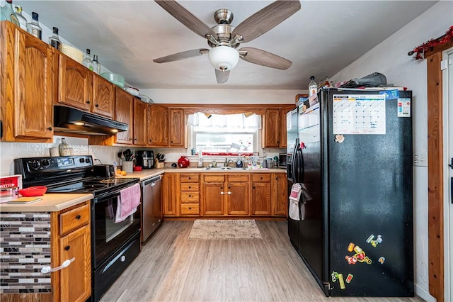 kitchen featuring sink, ceiling fan, black appliances, and light hardwood / wood-style flooring