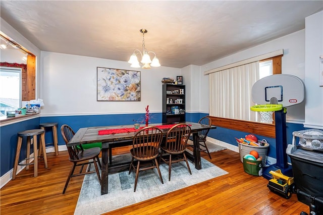 dining space with an inviting chandelier and hardwood / wood-style floors