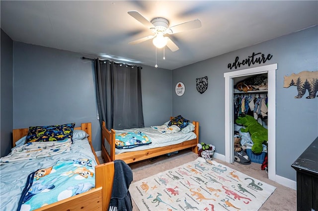 carpeted bedroom with ceiling fan and a closet