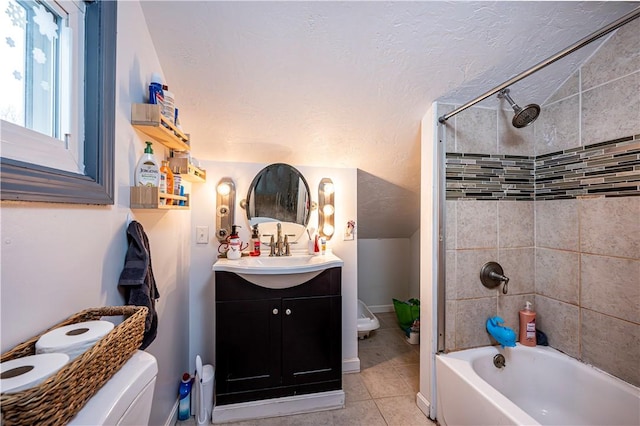 full bathroom featuring toilet, tiled shower / bath combo, tile patterned floors, and vanity