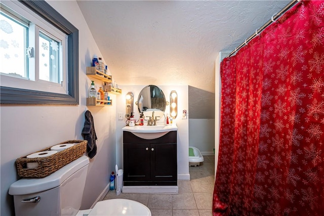 bathroom featuring tile patterned floors, lofted ceiling, vanity, and toilet