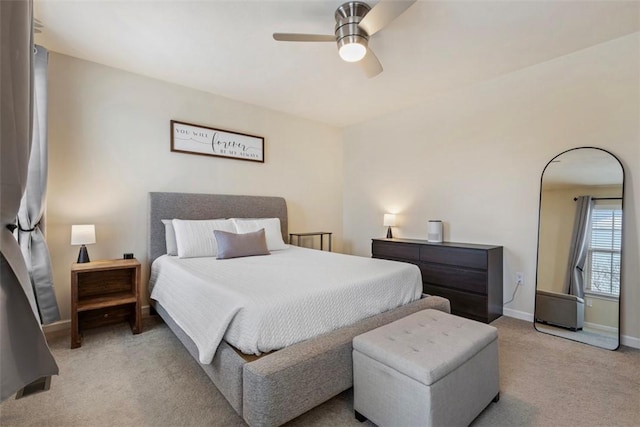 bedroom with ceiling fan and light carpet