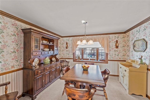 dining room featuring light colored carpet, a notable chandelier, and crown molding