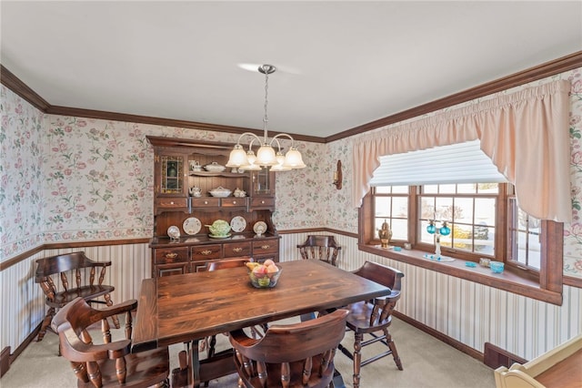 dining area with a notable chandelier, ornamental molding, and light carpet