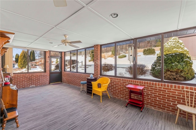 sunroom / solarium featuring ceiling fan