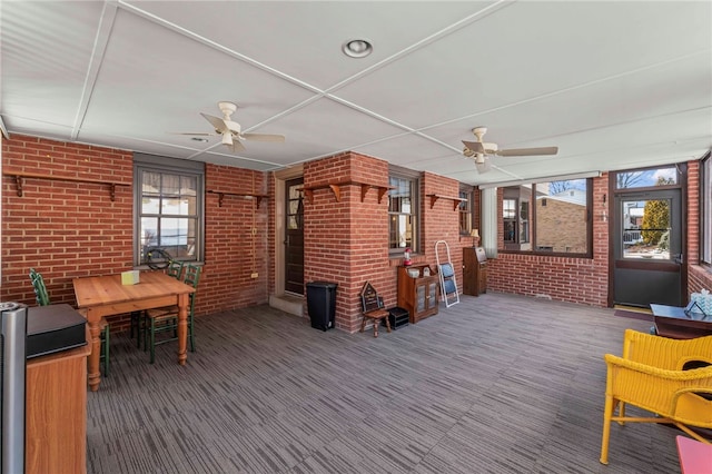 interior space with ceiling fan