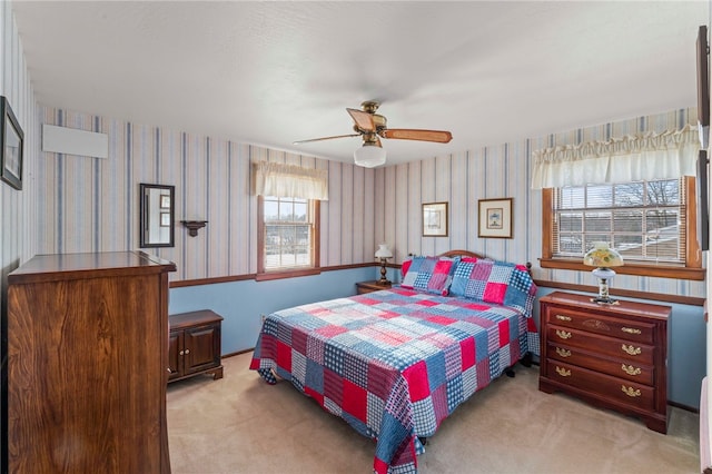 bedroom featuring light carpet and ceiling fan